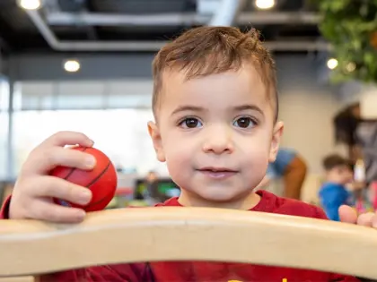 toddler boy holding a mini basketball